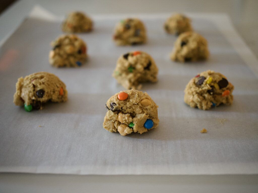 dough scooped onto lined baking sheet