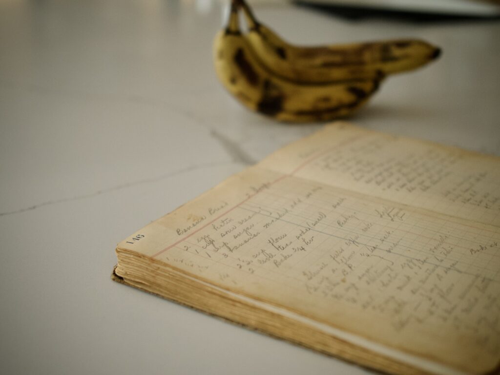 Grandma's cookbook in front of ripe bananas