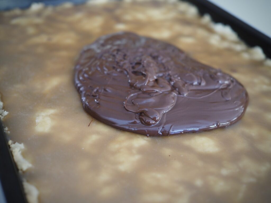 Melted chocolate on top of smooth caramel