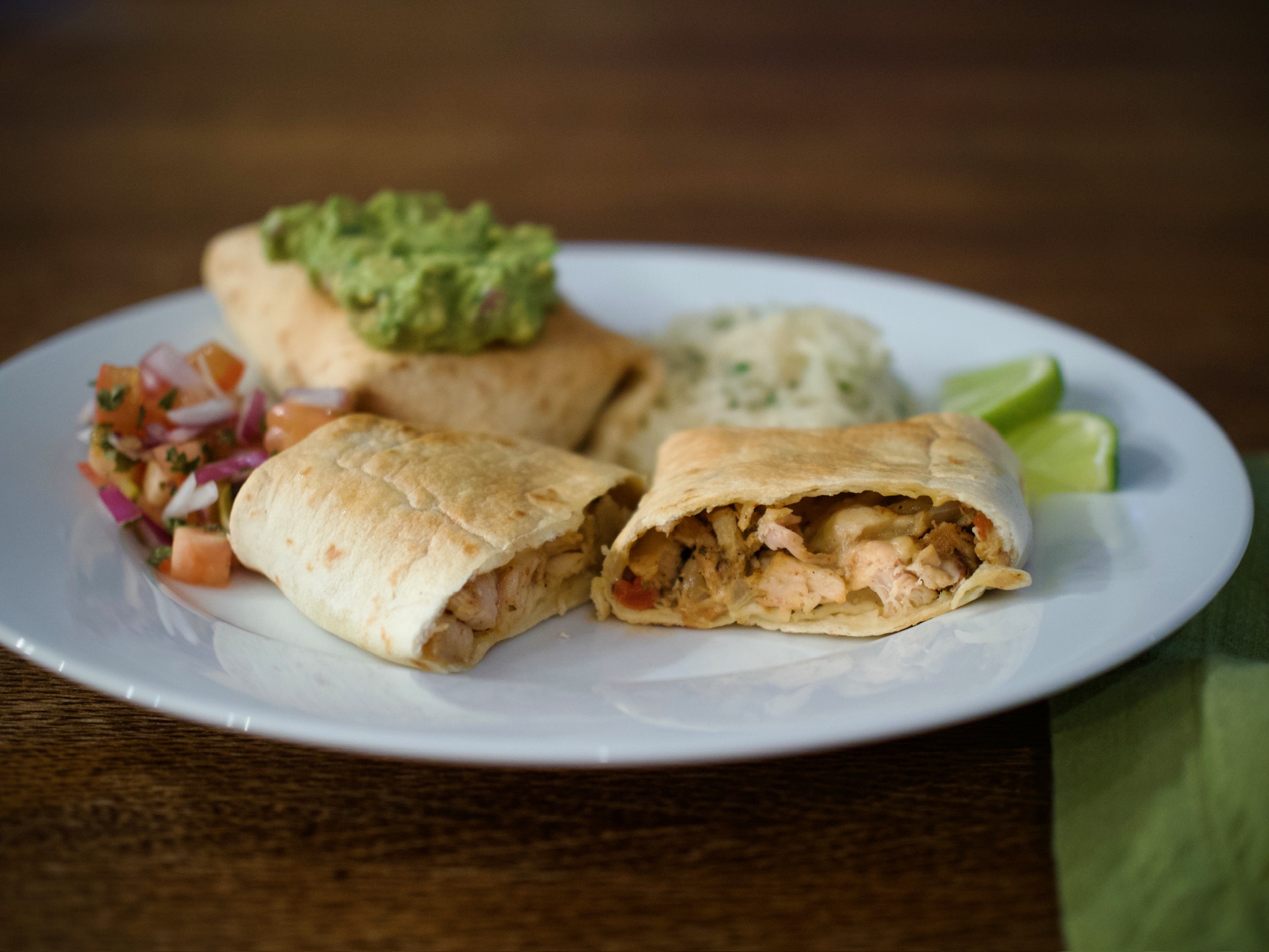 Plated chimichangas with guacamole, rice and pico do gallo